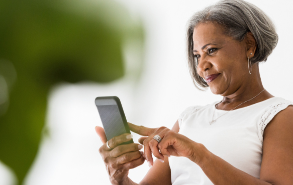 A mature black woman using her mobile phone